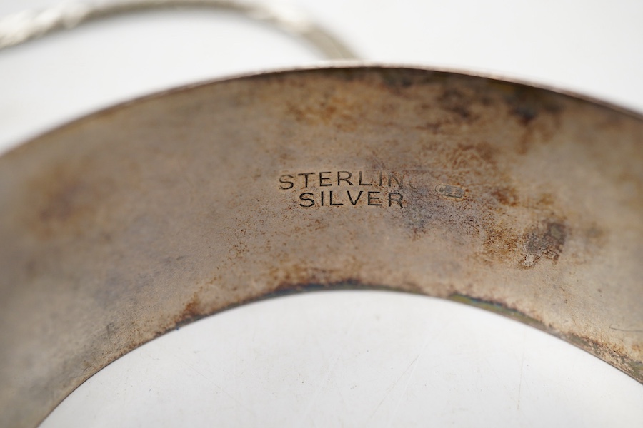 Two white metal bangles, one inscribed 'sterling silver' the other '925', together with a silver Uno A Erre chain, four other 925 chains, one curb link and four other white metal chains, longest approx. 69cm.
